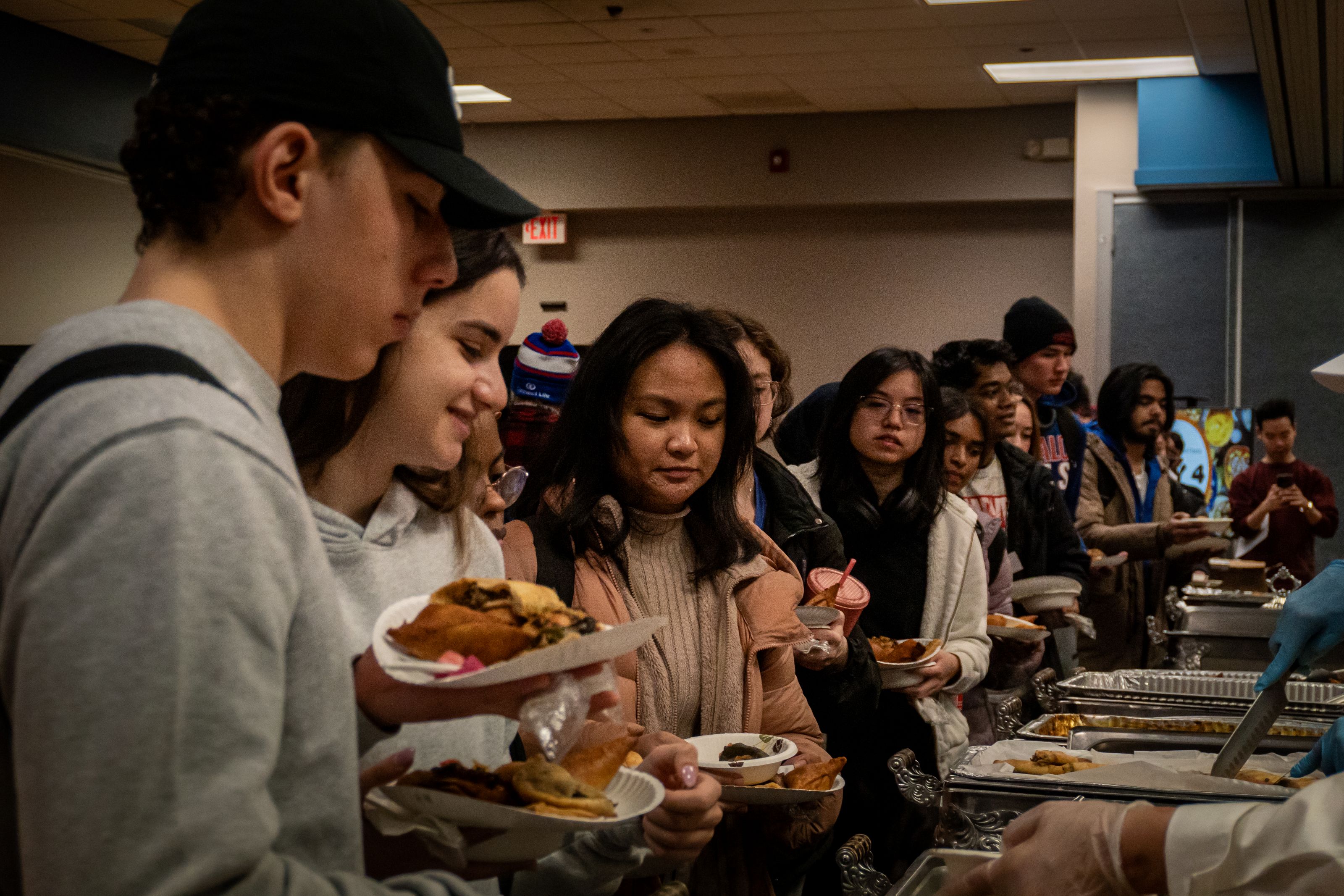 Trays of food in the middle, people on the left and right